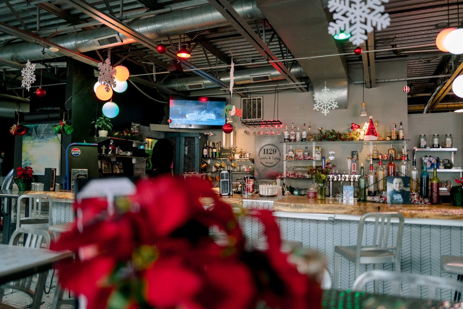 The real bar inside 1129 Spirits and Eatery with flowers in the foreground