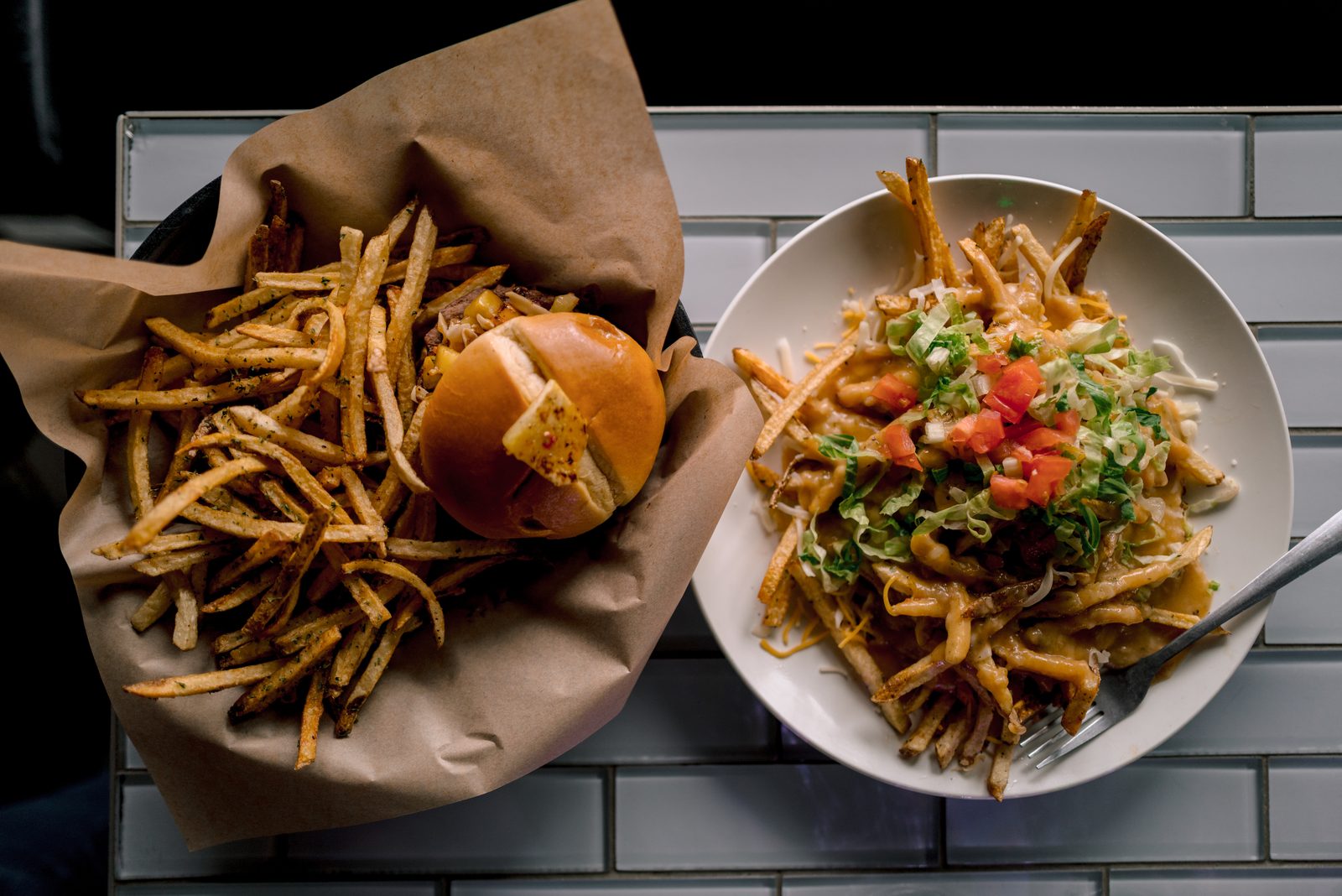 Overhead photograph of a burger, fries, and loaded fries at 1129