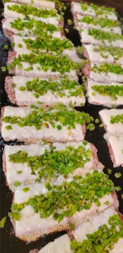 Rows of catered bread portions finished with green garnish