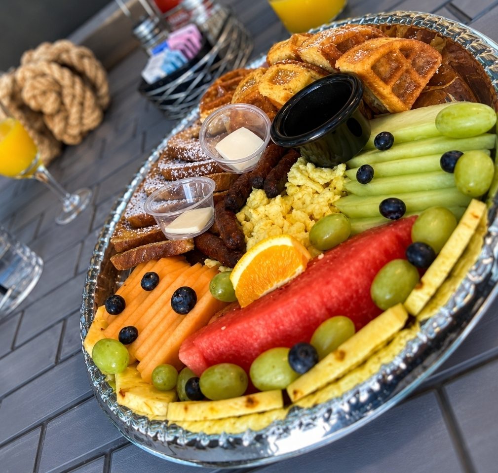 Large 1129 brunch platter with waffles, fruit, eggs, and breakfast favorites