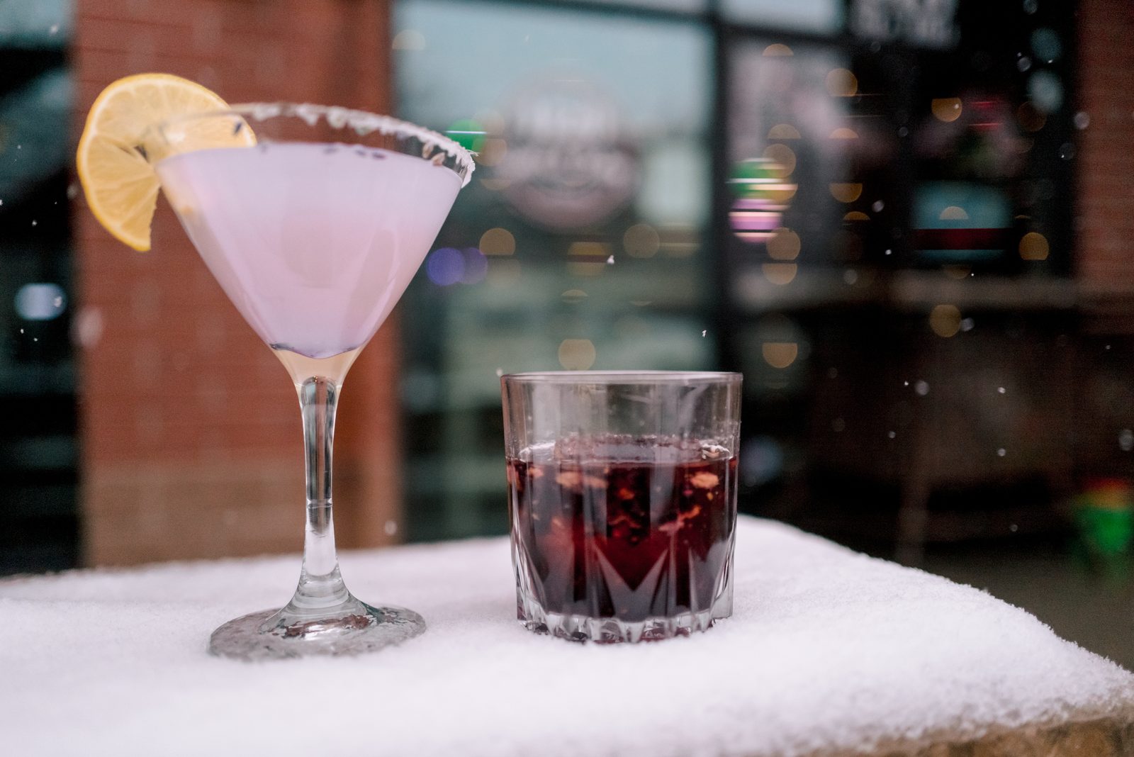 Purple cocktail and dark spirit displayed together at 1129