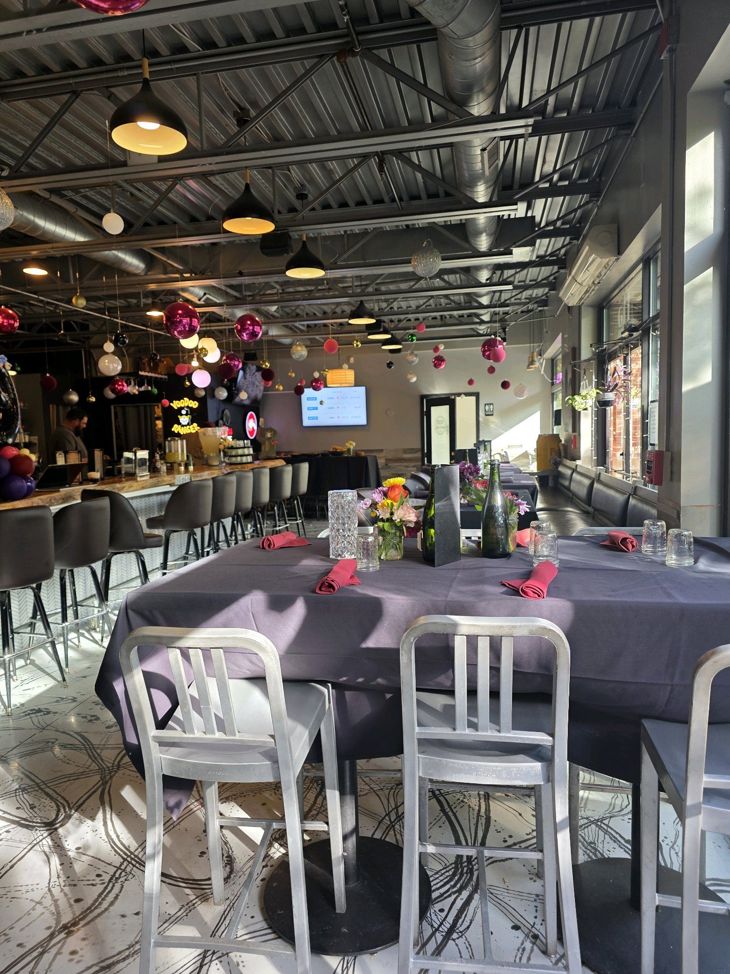 The 1129 dining room arranged with black table linens for a private event