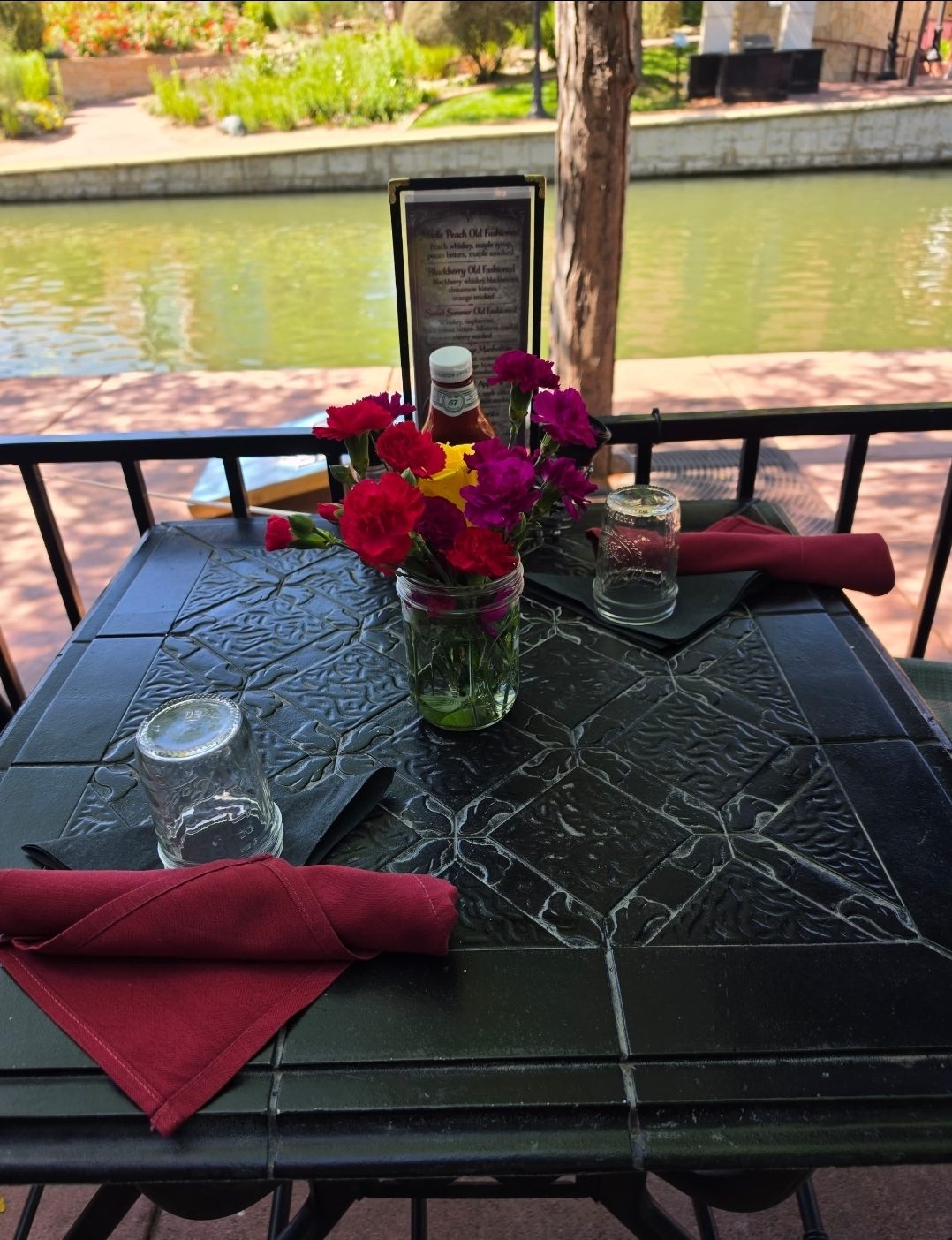 A set table beside the Pueblo Riverwalk at 1129
